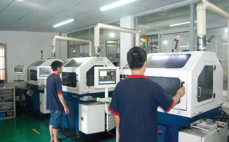 Operators working at enclosed machine stations